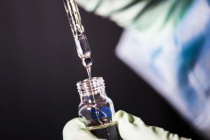 Captured inside a Centers for Disease Control and Prevention (CDC) laboratory, this image depicted a close view of a laboratory technician in the process of pipetting a sample of vitamin E acetate, which would be used in various tests conducted upon a number of electronic cigarettes, referred to as e-cigarettes, or e-cigs, and vaping pens.